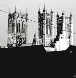 Silhouette of buildings against sky in city