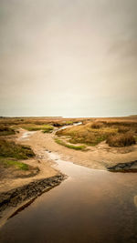 Scenic view of beach against sky during sunset