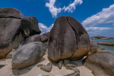 Close-up of rocks on shore against sky