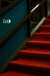 Close-up of exit sign on red staircase