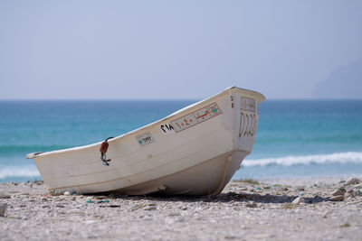 An fisherman boat parked on a beach in salalah oman.