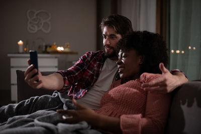 Multiracial couple talking with parents online