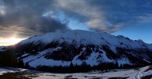 Scenic view of snow covered mountains against sky