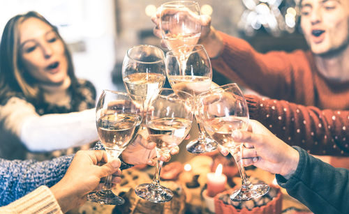 People toasting drinks in glasses