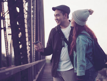 Couple standing on bridge