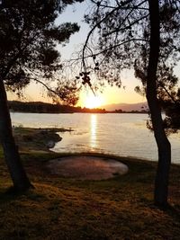 Scenic view of lake against sky during sunset