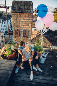 Couple sitting at building terrace