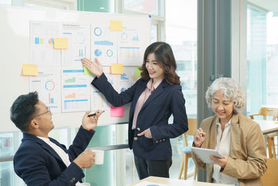 Group of asian corporate executives working together meeting in office.