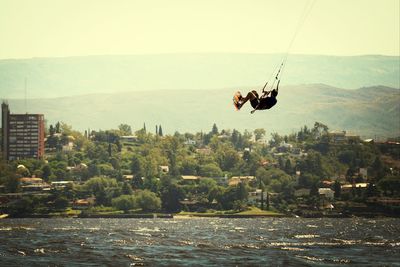 Kitesurfer flying above sea