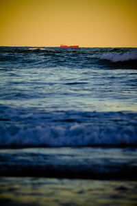 Scenic view of sea against clear sky during sunset