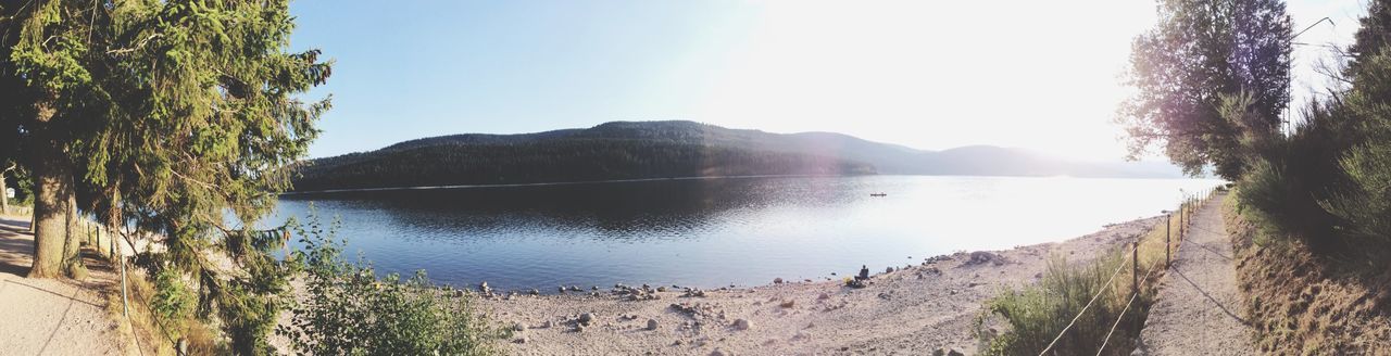 mountain, water, tranquil scene, tranquility, scenics, lake, beauty in nature, reflection, mountain range, sky, tree, nature, clear sky, idyllic, non-urban scene, landscape, sunlight, river, calm, outdoors