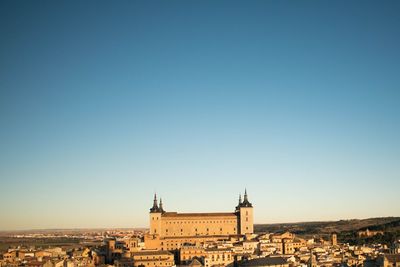 Townscape against clear blue sky