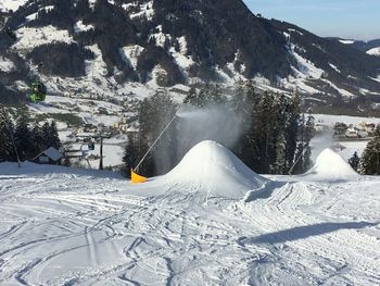 Snow covered landscape against mountain