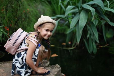 Full length of girl holding hat