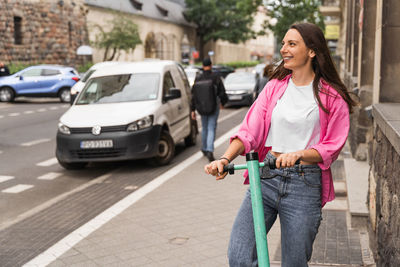 Portrait of young woman standing on street