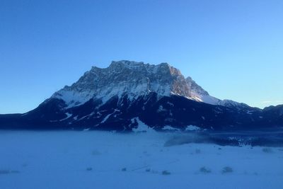 Scenic view of mountains against clear blue sky