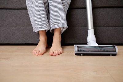 Low section of woman standing on hardwood floor