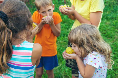 Cute kids eating snacks at park