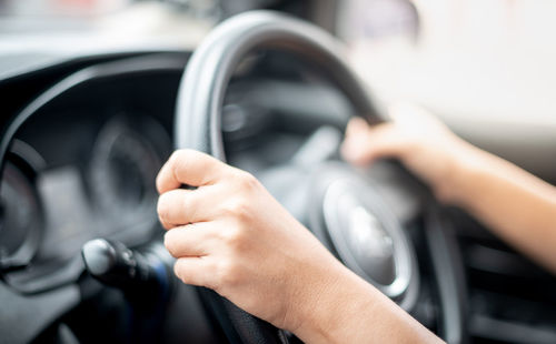 Close-up of person hand holding car