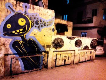 Graffiti on old building at night