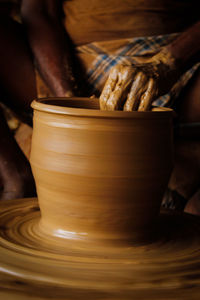 Close-up of man making pottery at workshop