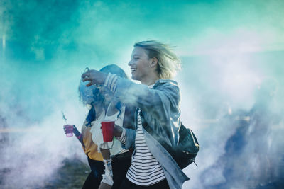 Young woman standing against the sky