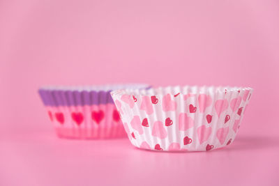 Close-up of cupcakes against pink background