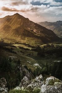 Scenic view of landscape and mountains against sky