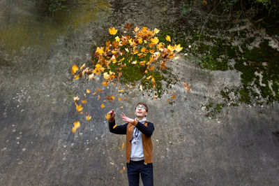 Portrait of young man standing by plants