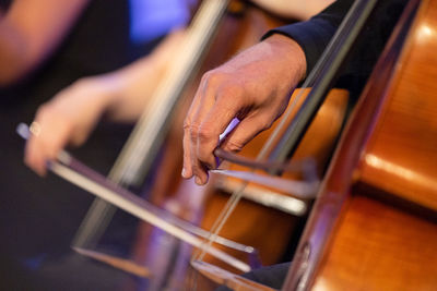 Midsection of man playing cello