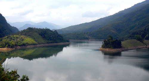 Scenic view of lake and mountains against sky