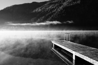 Pier over lake against sky