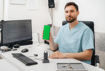 Portrait of young man working in office