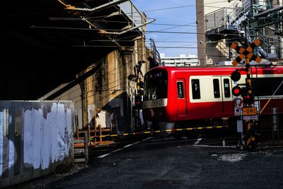 Train on railroad tracks in city against sky