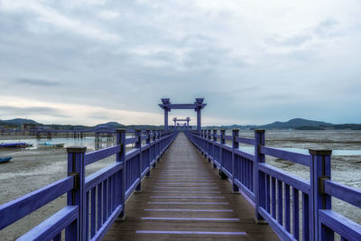 Pier over sea against sky