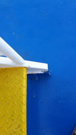 Directly above view of yellow metallic steps on ferry boat