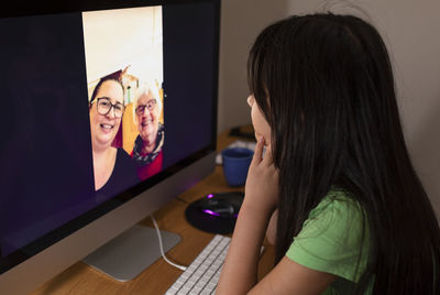 Girl talking via vide chat with grandmother