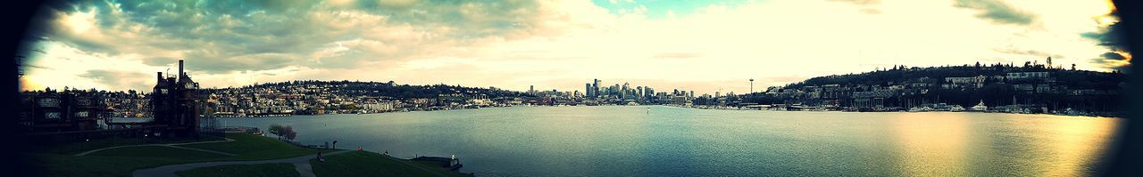 View of cityscape against cloudy sky