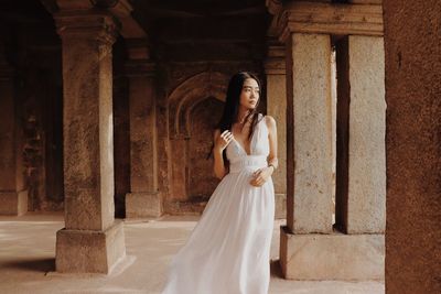 Woman standing in corridor of building