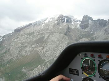 Close-up of hand on snow covered landscape