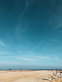 Scenic view of beach against blue sky