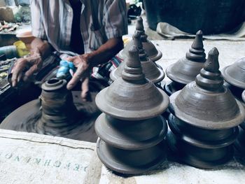 Midsection of man molding shape on pottery wheel