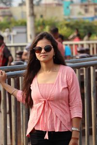 Young woman wearing sunglasses standing outdoors