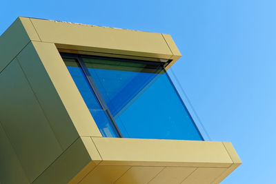 Low angle view of building against clear blue sky