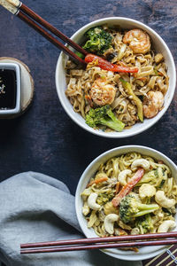 Two bowls with pad thai noodles