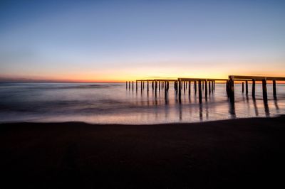 Scenic view of sea against clear sky at sunset