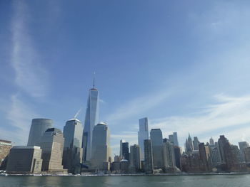 Modern buildings in city against cloudy sky