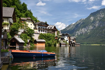 Low angle view of house by lake against mountains