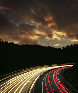 Light trails on road at dusk