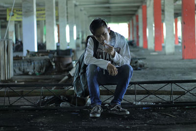 Young woman using mobile phone in city